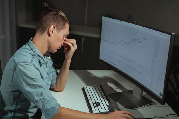 A frustrated indie developer looking at a computer screen displaying a complex financial model. The lighting is dim, highlighting the stress and anxiety of facing unexpected budget changes.