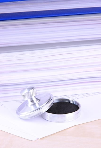 A gavel resting on a stack of legal documents, with a digital screen in the background displaying lines of code and gaming icons, representing the intersection of legal regulations and the digital gaming industry.