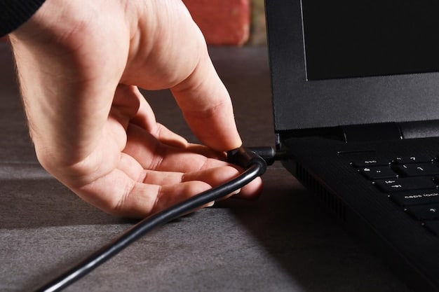 A hand plugging an ethernet cable into the back of a gaming PC. The focus is on the connection, highlighting the importance of wired connections over Wi-Fi.