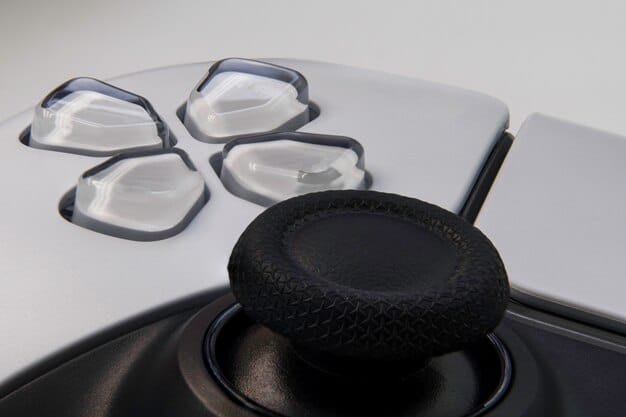 Close-up shot of the Xbox Adaptive Controller, highlighting its various ports and customizable buttons. The controller is connected to a variety of assistive devices, showcasing its versatility.