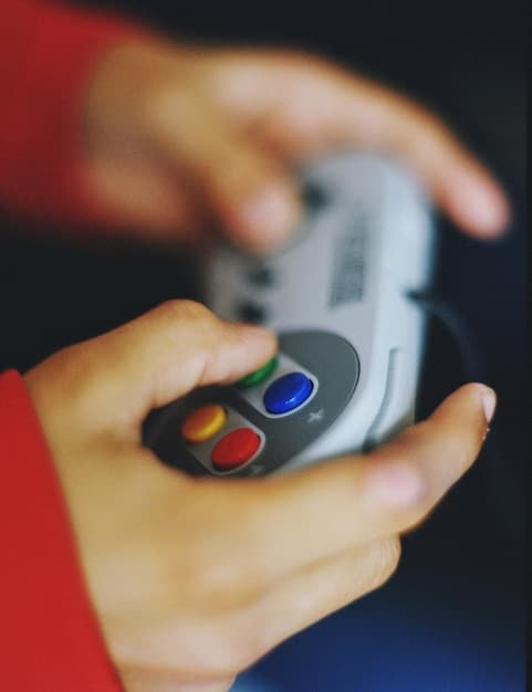 A close-up shot of a hand hovering over a game console controller, with a TV screen displaying a digital game storefront UI filled with various games available for download. The lighting highlights the screen and controller, emphasizing the digital gaming experience.