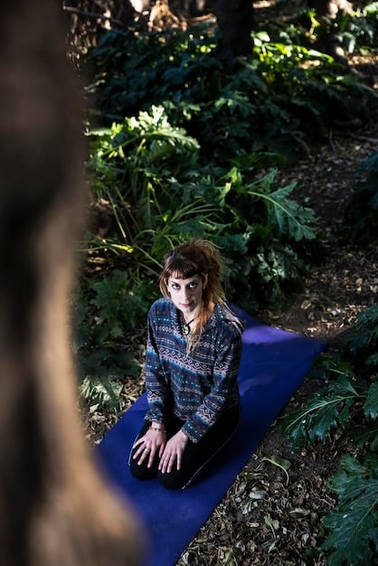 A split image showing one side with a person intensely focused on a video game on a large screen, contrasted with the other side showing a person doing yoga outdoors in a sunny park.