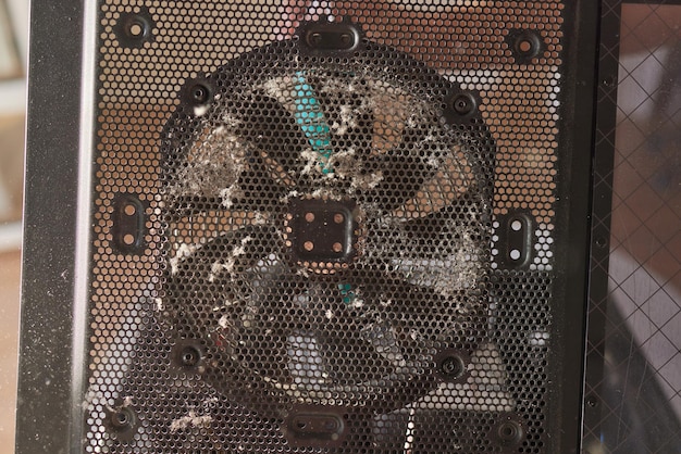 A detailed image of a dirty console fan completely covered in dust, placed next to a clean fan for comparison. The image highlights the importance of cleaning for proper console function.