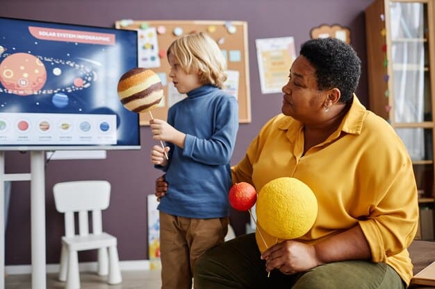 A young student excitedly explaining a complex strategy from a console game to their teacher and classmates, showcasing teamwork and communication skills.