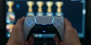 Gamer holding PS5 controller, trophy pop-ups on screen