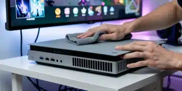 Gamer cleaning a modern console with a microfiber cloth, highlighting essential maintenance.